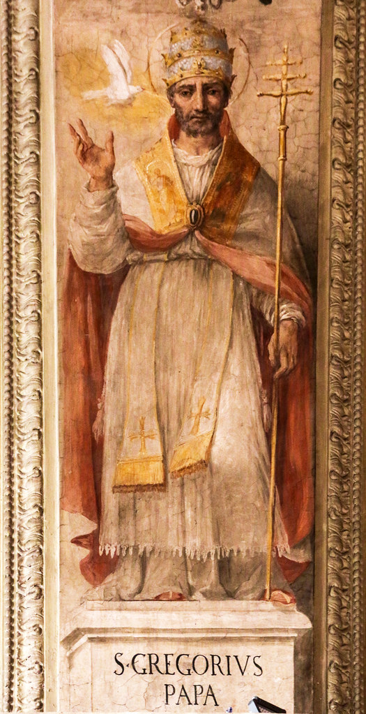 Ancient-style painting of a seated bearded man, in a thoughtful pose with hand on chin, wearing layered robes in rich earth tones, over a floral design.