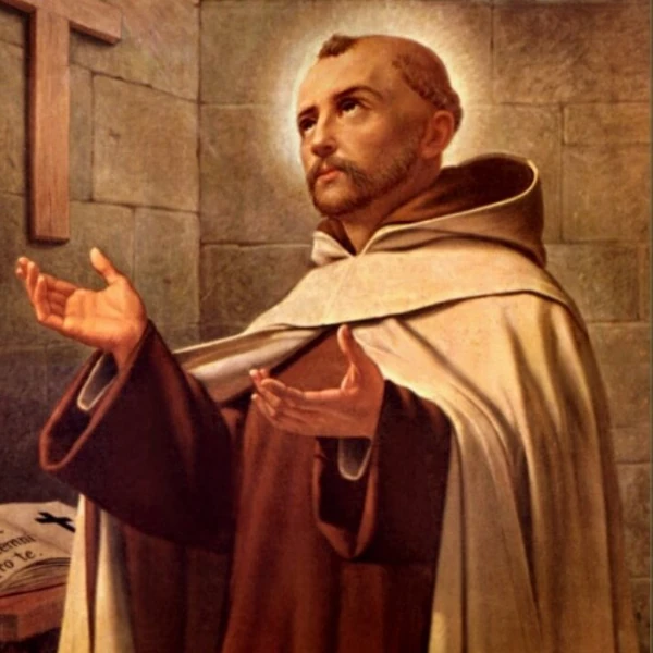 A serene monk in a brown robe with a halo, praying earnestly with open hands. A stone wall and a cross are in the background. Elegant flowers border the image.