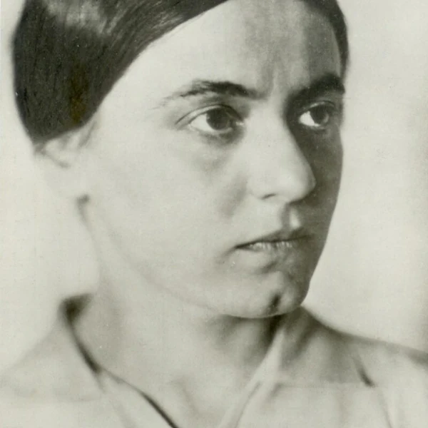 Black and white portrait of a woman with a contemplative expression, looking to the right. Her hair is pulled back. Floral outline on the left side.