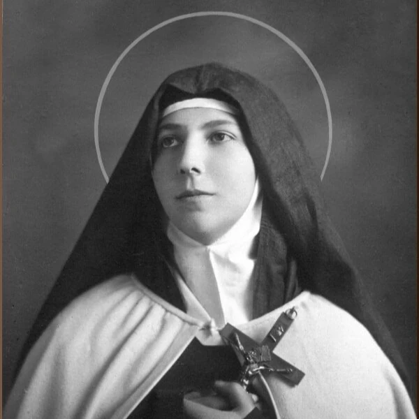 Black and white photo of a serene nun in traditional habit, holding a crucifix with a halo effect. Delicate floral graphics decorate the corner.
