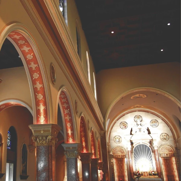 Interior of a church with ornate arches and illuminated altar. Decorative floral illustration outlines the image, adding a serene and artistic touch.